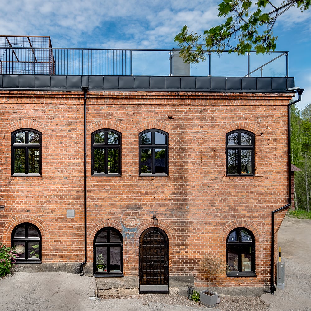Inward-opening black wooden windows with semi-circular top