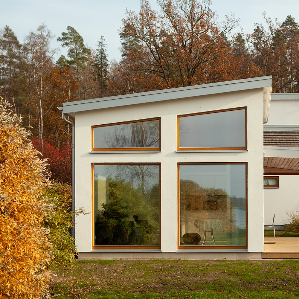 Inward-opening wooden windows in transparent stain
