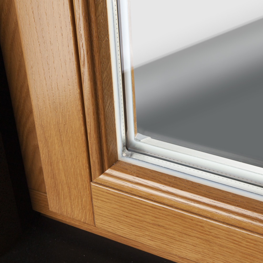 Concealed glass mounting on lacquered oak window